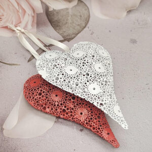 Charming Valentine's Day hanging decorations featuring intricate hollow metal heart craft pendants.