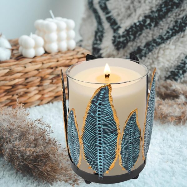Southwest-style metal feather candle holder with removable glass hurricane chimney.