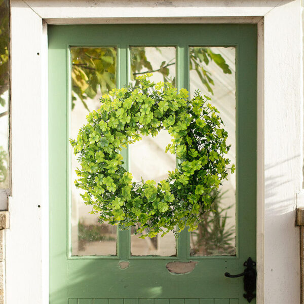 Festive St. Patrick's Day artificial shamrock garlands and wreaths for lucky door decor.