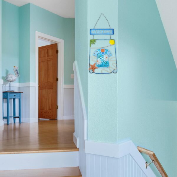 Tropical metal welcome sign featuring a coastal, sun-drenched beach theme.