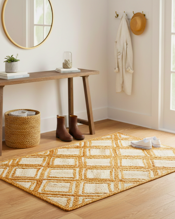 Handcrafted 24x36 inch natural jute rug featuring a classic braided diamond pattern.
