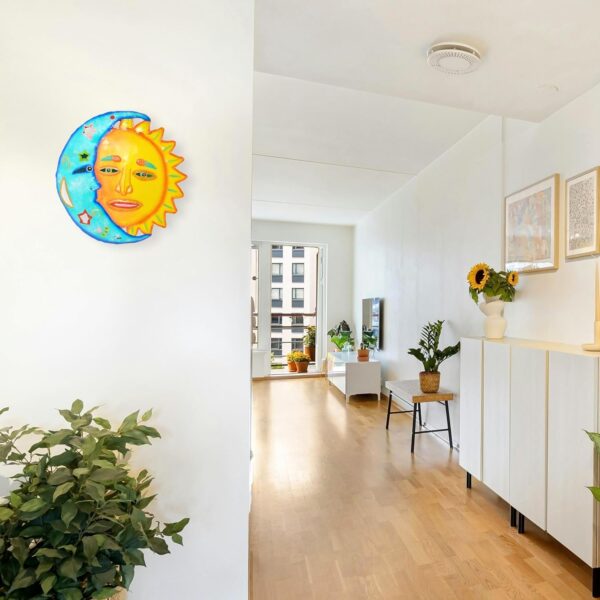 Handcrafted Haitian metal sun and moon face wall art decor.