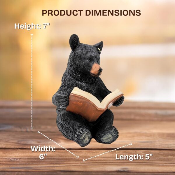 Charming solar-powered black bear reading a glowing book garden light.