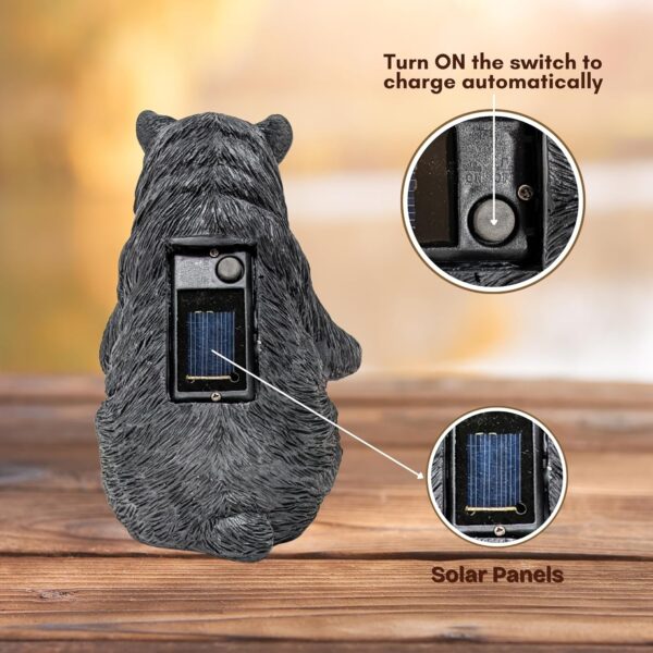 Charming solar-powered black bear reading a glowing book garden light.